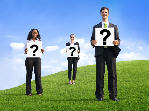 Free Coaching Questions shown by 3 people standing holding question marks