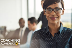 Happy Woman in Office with Colleagues for New Career Coaching