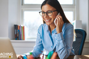 Happy Coach on phone with New Coaching Clients