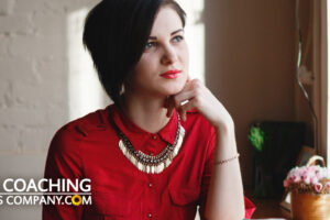 Woman pondering critic in red dress in coffee shop