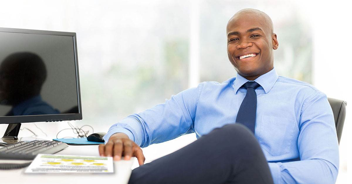 Smiling Coach with Life Coaching Exercise at Desk