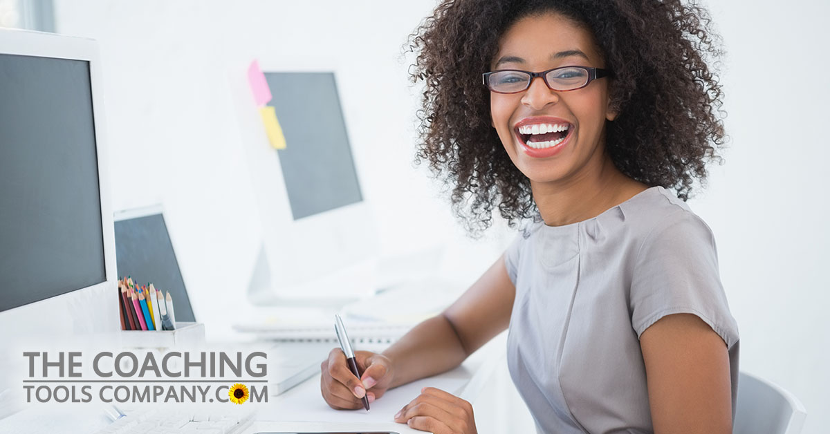 Happy Client Using Goal Setting Tips at Desk