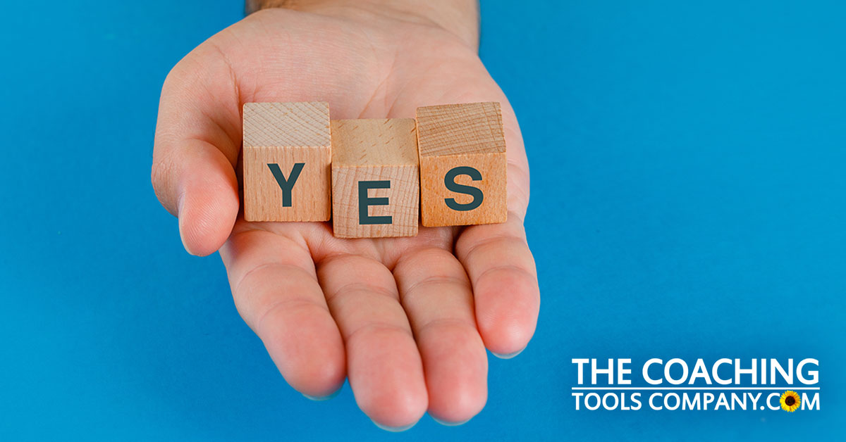 Client's Hand Saying Yes with Wooden Cubes