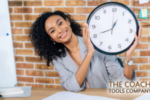 Happy Client Holding Clock at desk for Time Management