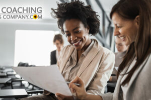 Two people in Team Coaching session reviewing Welcome Kit