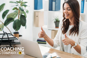 Happy Successful Client at desk giving the thumbs up