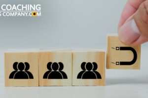 Hand holding magnet cube attracting people cubes