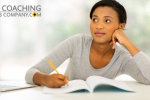 coach at desk journaling
