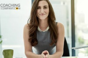 confident female coach sitting at desk