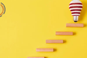 Steps leading upward toward a covered lightbulb.