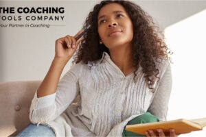 Coach reflecting with a journal as part of a self-care practice