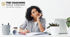 Woman reflecting on her thoughts while working at a desk